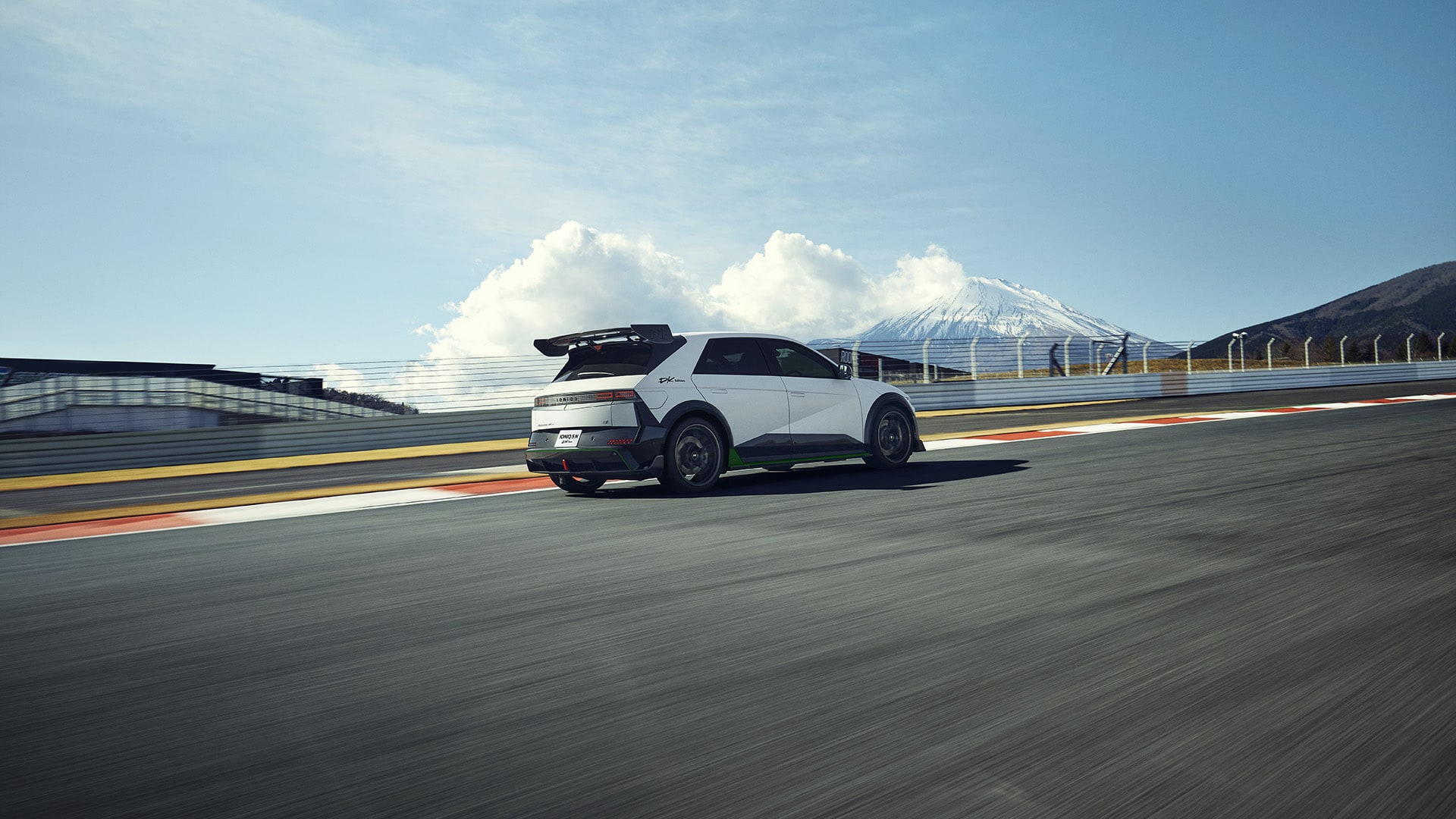 Right side view of the IONIQ 5 N DK Edition running on a straight track.